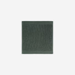 Dark green organic cotton washcloth.