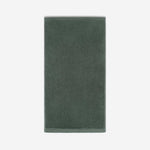 Deep forest green cotton bath sheet in vertical orientation with woven border bands, shown against a white background.