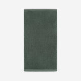 Deep forest green cotton bath sheet in vertical orientation with woven border bands, shown against a white background.