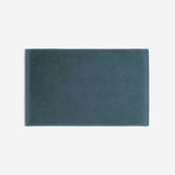 Teal cotton bath sheet in horizontal orientation with woven border bands, shown against a white background.