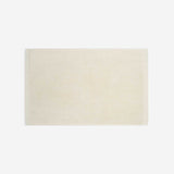Cream cotton bath sheet in horizontal orientation with woven border bands, shown against a white background.