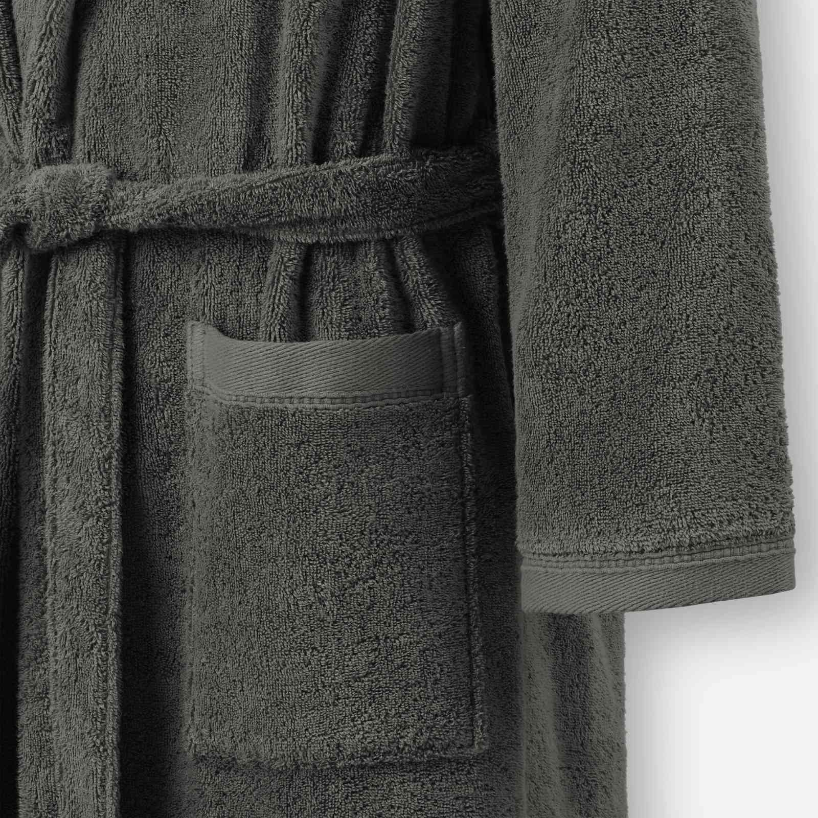 Close-up of a dark grey terry cotton bathrobe showing the waist tie belt, front patch pocket, and sleeve cuff detail.
