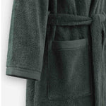 Close-up of a mosstone terry cotton bathrobe showing the waist tie belt, front patch pocket, and sleeve cuff detail.