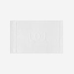 White bath mat with a tonal embroidered logo, shown in horizontal orientation against a white background.