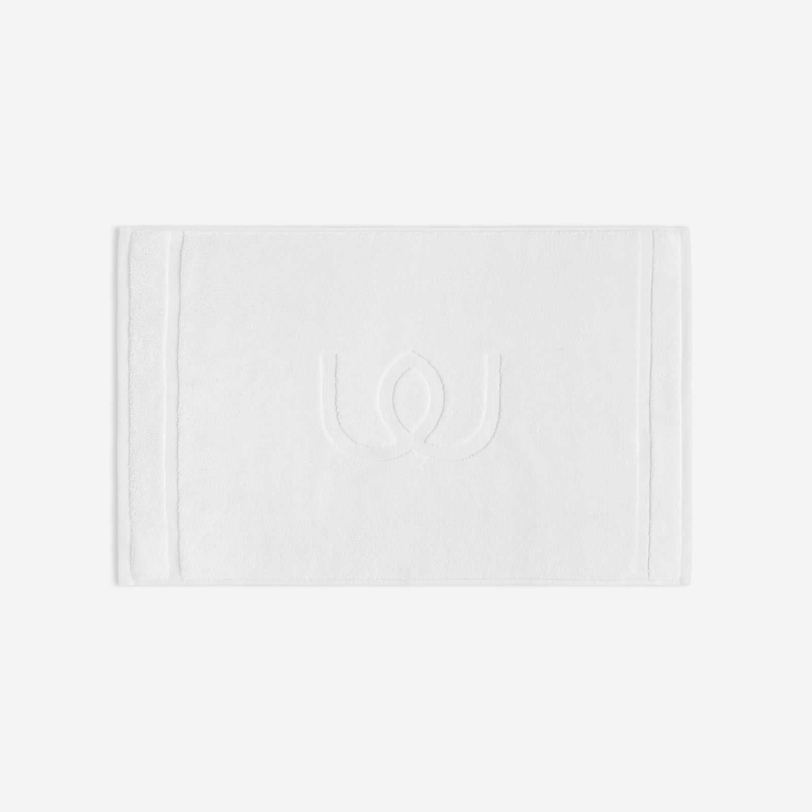 White bath mat with a tonal embroidered logo, shown in horizontal orientation against a white background.