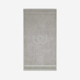 Light gray bath mat with a tonal embroidered logo, shown against a white background.