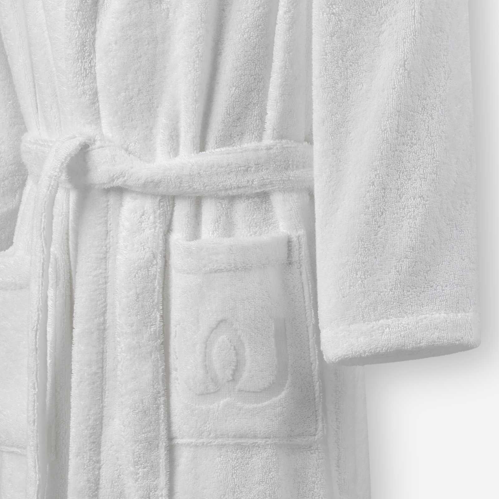 Close-up of a white terry cotton bathrobe showing the belt and front pocket with embroidered logo detail.