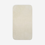 Top view of a light cream organic cotton bath sheet with rounded corners, displayed flat on a white background.