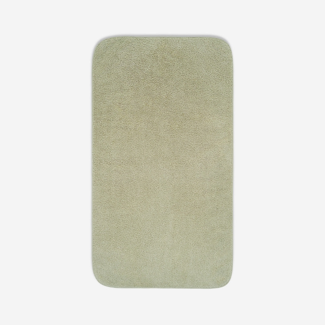 Top view of a sage green cotton towel with rounded corners, displayed flat on a white background.