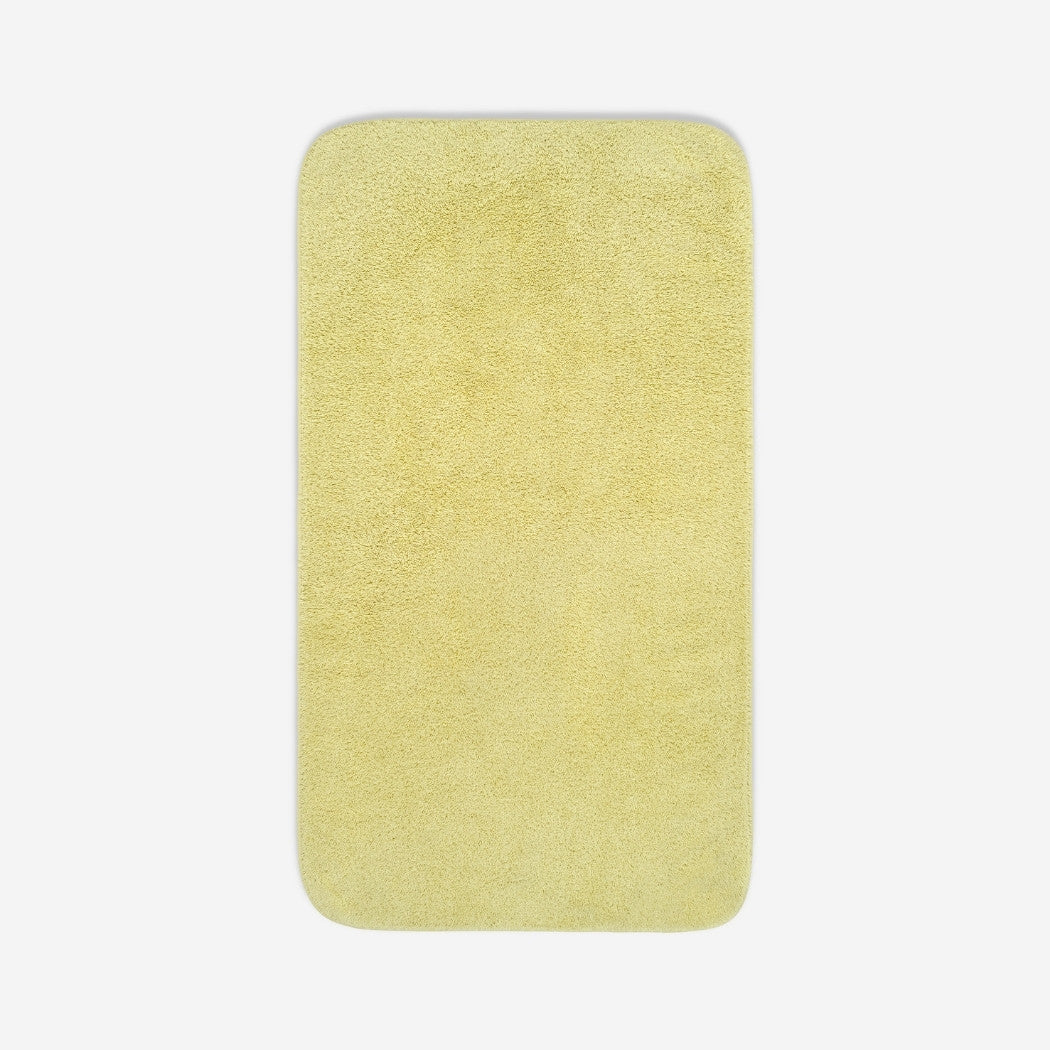 Top view of a yelloe organic cotton towel laid flat with rounded corners, shown on a white background.