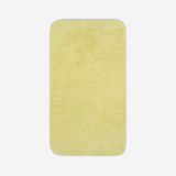 Top view of a yelloe organic cotton towel laid flat with rounded corners, shown on a white background.