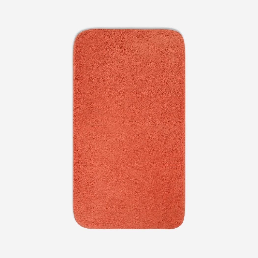Top view of a orange organic cotton bath sheet with rounded corners, displayed flat on a white background.