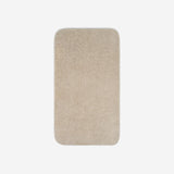Top view of a beige cotton bath towel with rounded corners, displayed flat on a white background.