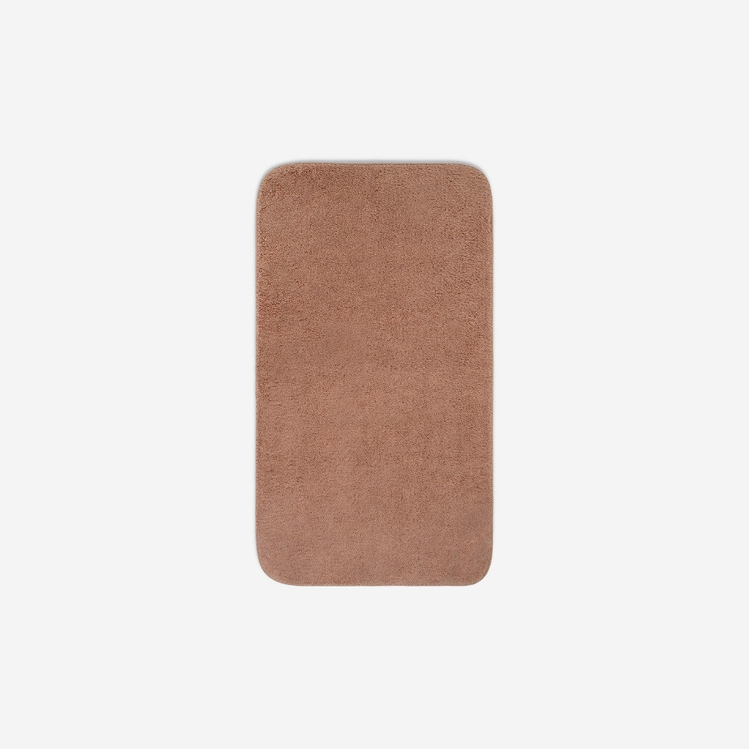 Top view of a dusty rose organic cotton face towel with rounded corners, displayed flat on a white background.