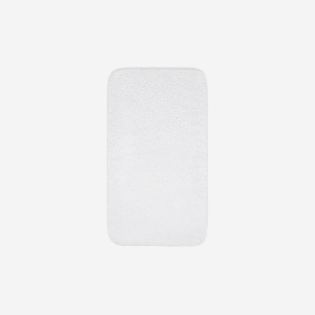 Top view of a white cotton face towel laid flat with rounded corners, shown on a white background.