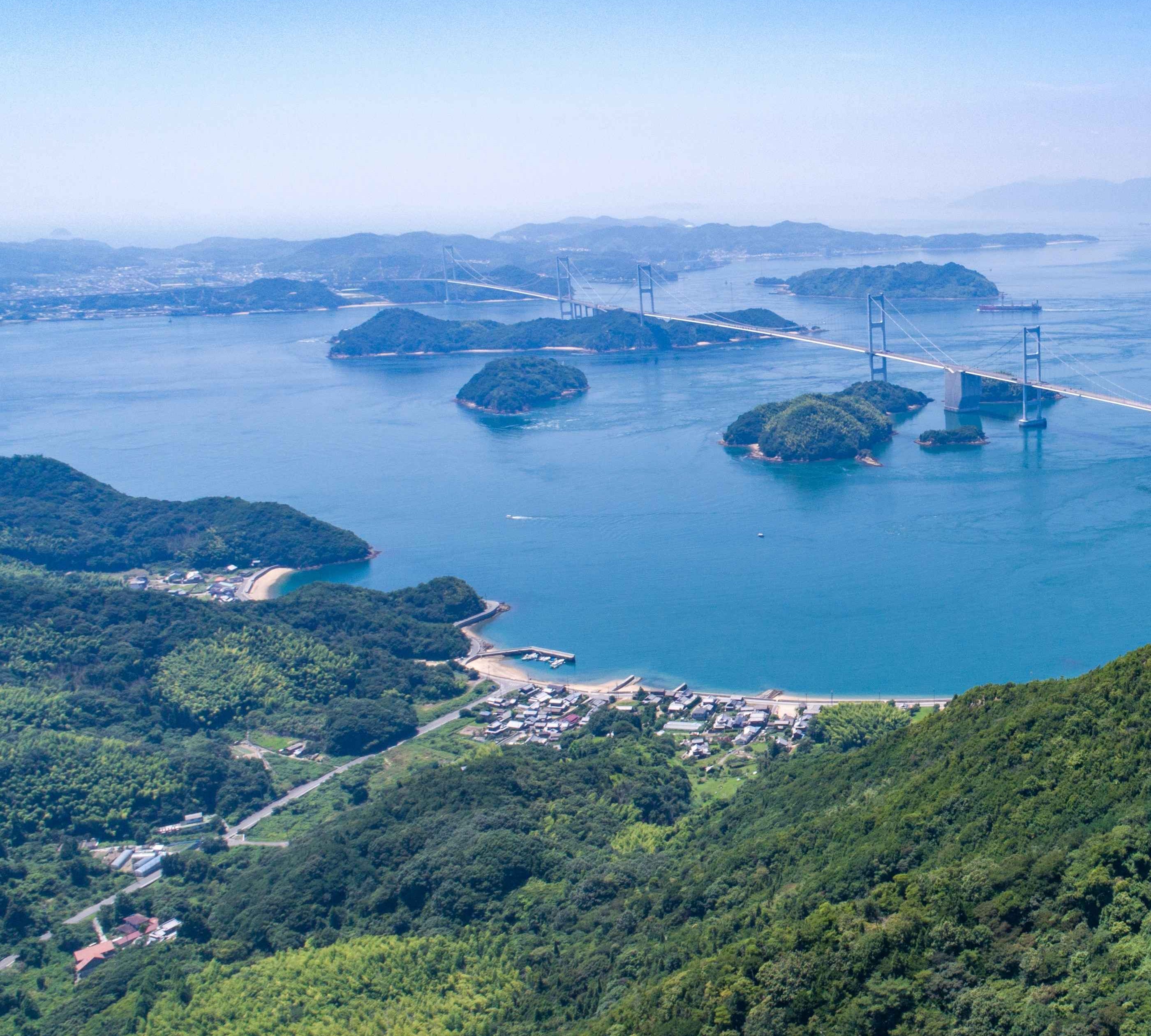 Panoramic view of Setonaikai National Park in Imabari, with green islands, blue sea and a bridge across the archipelago
