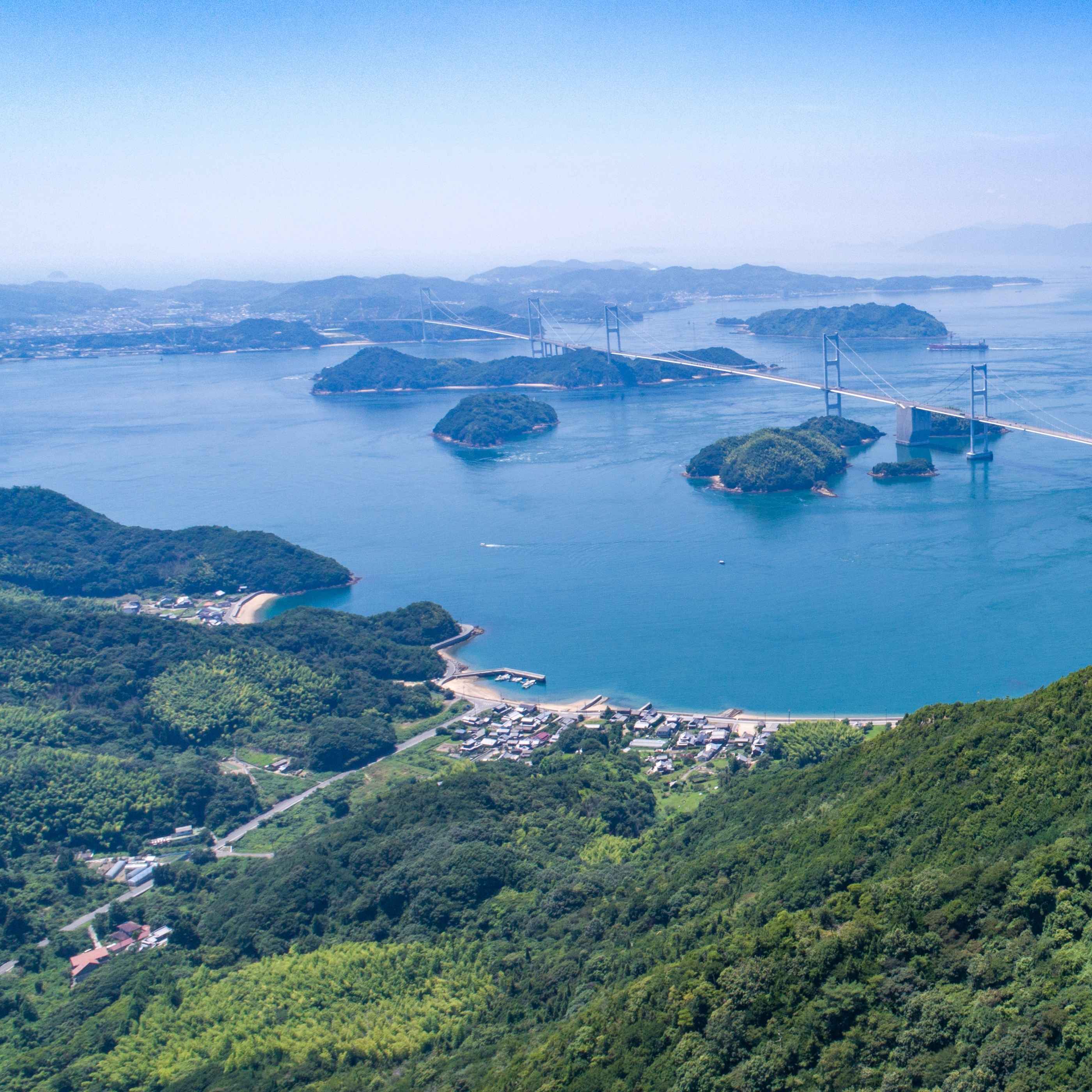 Panoramic view of Setonaikai National Park in Imabari, with green islands, blue sea and a bridge across the archipelago