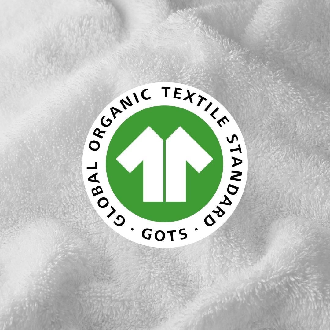 Global Organic Textile Standard (GOTS) logo on a textured fabric background
